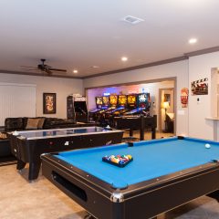 downstairs game room with pool table and pinball machines