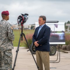 Randy being interviewed by a soldier with a camera