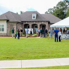 2019 Community Spirit Home Event being held outside a brick house in Mill Creek Farms
